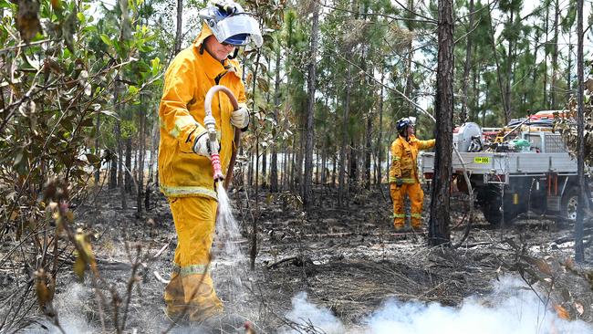 Firefighters extinguish spot fires at Landsborough on October 30. Picture: NCA NewsWIRE / John Gass