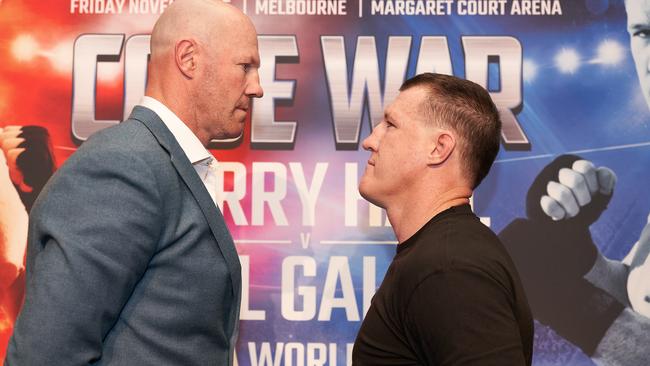 Former AFL player Barry Hall (left) and NRL Cronulla-Sutherland Sharks player Paul Gallen face off during a Code War boxing launch in Melbourne, Wednesday, October 2, 2019. (AAP Image/Stefan Postles) NO ARCHIVING