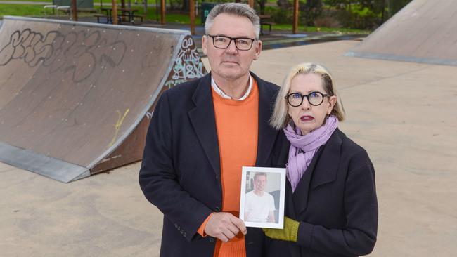 Angela Tolley, with her husband Neil Ward and a picture of their son Paris, who took his own life. Picture: Brenton Edwards