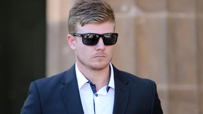 Ex-AFL rookie Joshua William Glenn leaves the Adelaide Magistrates Court in Adelaide. Picture: AAP Image/Kelly Barnes