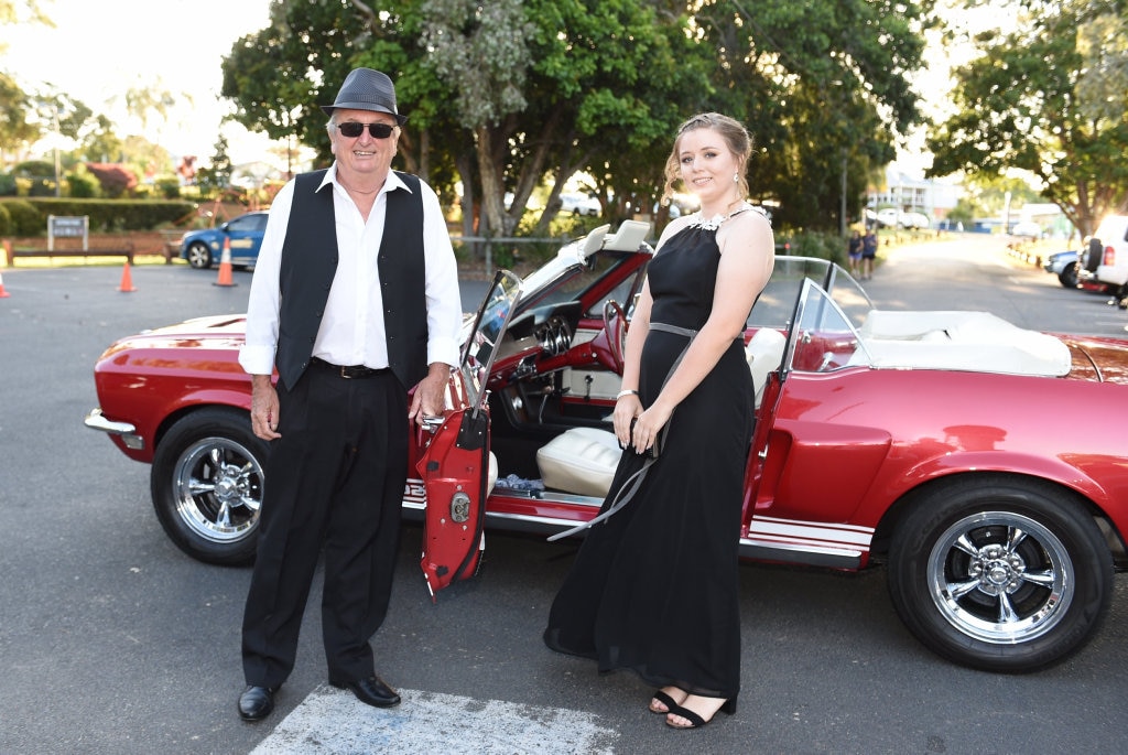 Hervey Bay High formal at the Waterfront - Ashlee Bates gets a ride with her Uncle Russ in his bright red Mustang. Picture: Alistair Brightman