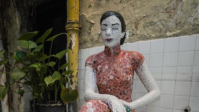 There’s the graceful lady artwork made from thousands of porcelain pieces keeping guard from her seat. Picture: Supplied.