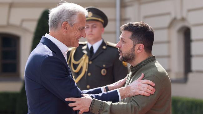 Jonas Gahr Store, left, is embraced by Volodymyr Zelensky in Kyiv. Picture: AFP