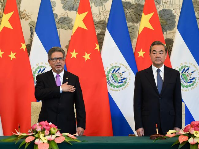 El Salvador's Foreign Minister Carlos Castaneda, left, stands next to China's Foreign Minister after the Central American nation ditched diplomatic ties with Taiwan in yet another victory for Beijing in its campaign to isolate the island. Picture: AFP