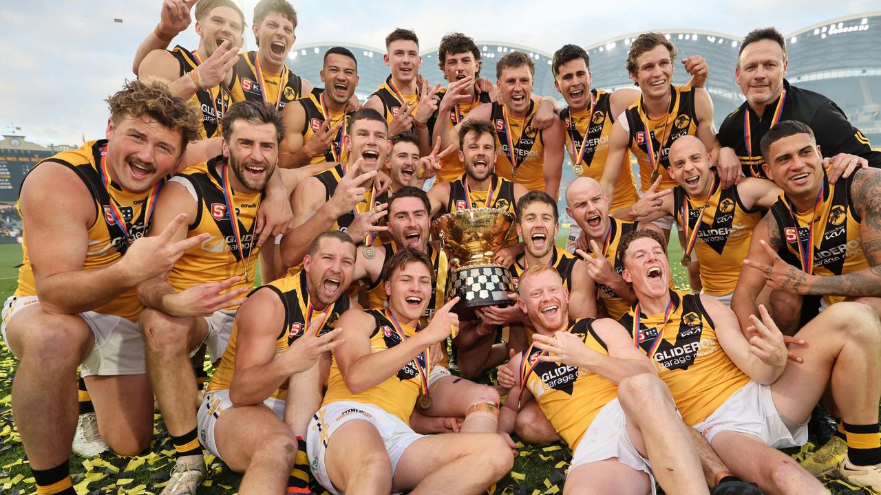 Will Gould (left) celebrates with his Glenelg teammates after winning this year’s SANFL premiership. Picture: David Mariuz/SANFL