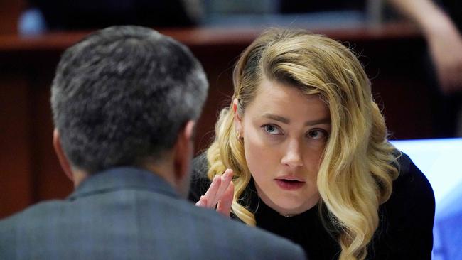 Amber Heard talks to her lawyer in court on Monday. Picture: AFP