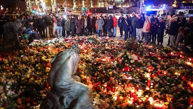 People lay flowers at a makeshift memorial near the site of the Christmas market attack. Picture: Ronny Hartmann / AFP