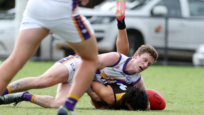 WRFL: Altona’s Connor Menadue tackles Danny Grmusa of Werribee Districts. Picture: George Sal