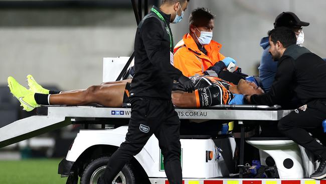 Michael Chee-Kam is stretchered from the field after suffering a seizure following a head knock in the Tigers’ match against the Eels. Picture: Phil Hillyard