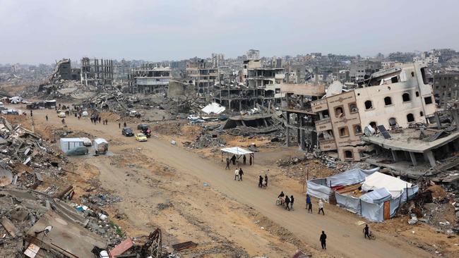 People walk among the ruins of Jabalia in the northern Gaza Strip on Wednesday. Picture: AFP