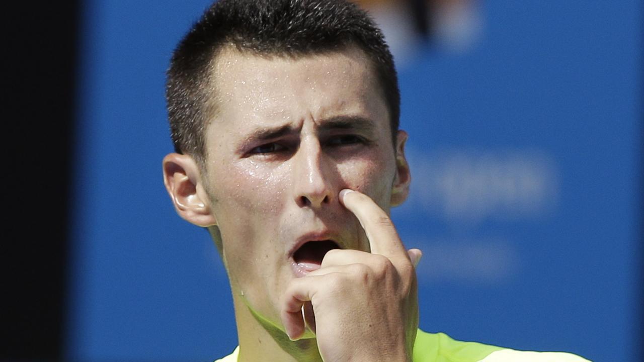Bernard Tomic of Australia gestures between the game as he plays Germany's Tobias Kamke during their first round match at the Australian Open tennis championship in Melbourne, Australia, Monday, Jan. 19, 2015.(AP Photo/Lee Jin-man)