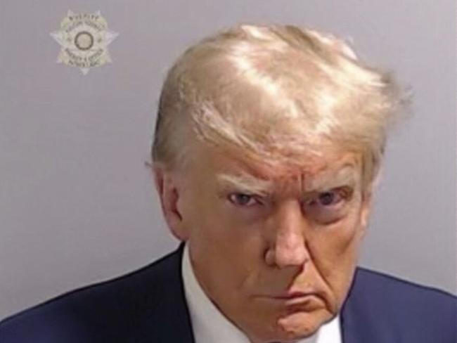 This handout image released by the Fulton County Sheriff's Office on August 24, 2023 shows the booking photo of former US President Donald Trump. Donald Trump surrendered on racketeering charges and had his mugshot taken at a Georgia jail on August 24, setting the stage for a fourth criminal trial next year as he bids to reclaim the White House. The 77-year-old former president will be arrested at Atlanta's notorious Fulton County Jail, accused of conspiring with 18 codefendants to try to overturn the 2020 election result in the key southern state. The booking of the billionaire real estate tycoon in his fourth and final indictment sets up a year of unprecedented courtroom drama as he tries to balance appearing in the dock with hitting the campaign trail. (Photo by FULTON COUNTY SHERIFF'S OFFICE / AFP) / RESTRICTED TO EDITORIAL USE - MANDATORY CREDIT "AFP PHOTO / FULTON COUNTY SHERIFF'S OFFICE " - NO MARKETING - NO ADVERTISING CAMPAIGNS - DISTRIBUTED AS A SERVICE TO CLIENTS