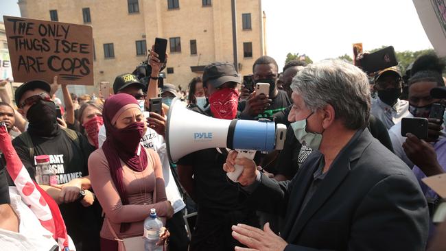 Kenosha mayor John Antaramian uses a bull horn to talk to people gathered in front of the police station. Picture: AFP