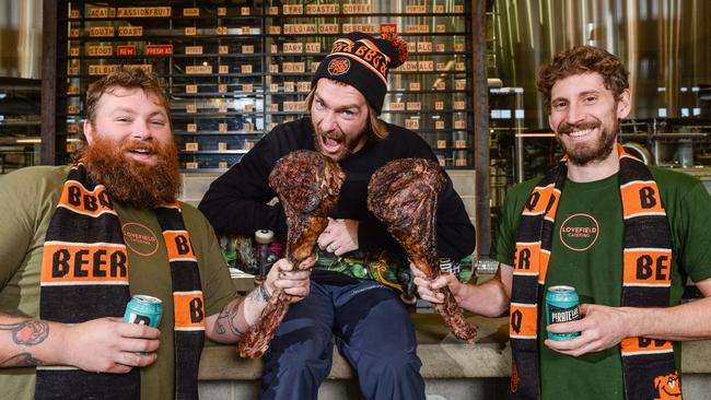 Pro skater Beau Hinge, middle, with Gus Love and Jack Winfield from Lovefield Catering with tomahawk steaks from Minko Farm via Ellis Butchers in McLaren Vale. They were set to be part of the Beer and BBQ festival. Picture: Brenton Edwards.