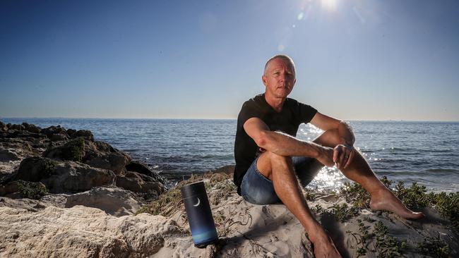 Martin Black with his parents’ ashes at South Cottesloe. Picture: Colin Murty