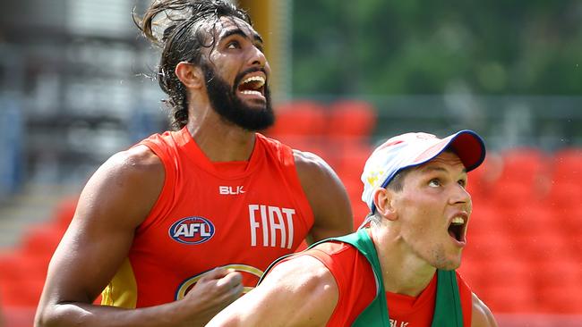 Tom Nicholls, left, wrangles with Dan Currie at Suns training. Picture: David Clark