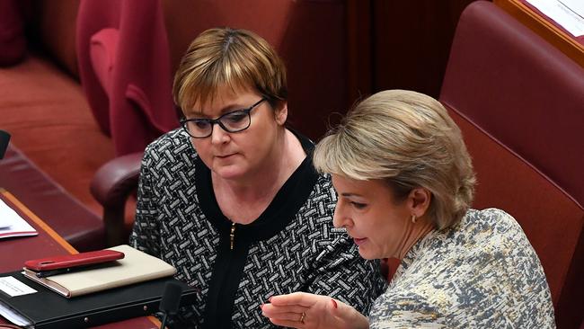 Senator Linda Reynolds and Senator Michaelia Cash in the Senate at Parliament House in 2021.