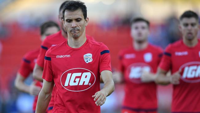 Adelaide United captain Isaias Sanchez leads the Reds off the pitch. Picture: AAP Image/David Mariuz