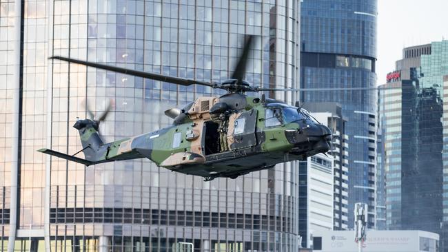 An MRH90 Taipan helicopter from the School of Army Aviation in Oakey conducts a low-level flying display along the Brisbane River in the CBD.