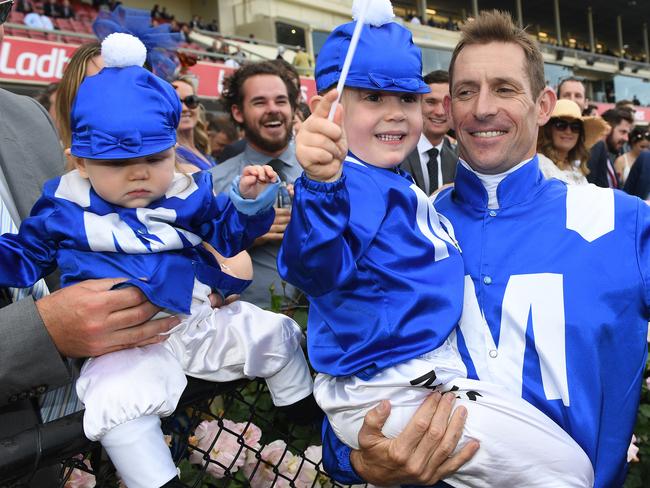 A day for everyone: Jockey Hugh Bowman with two children dressed in the colours of Winx. Picture: AAP