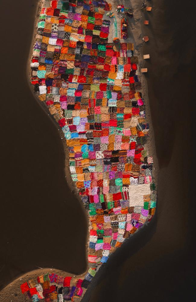 An aerial drone reveals the vibrant expanse of an open-air laundry along the Yamuna river, transforming the scene into a colourful tapestry. Picture: Alexandre Pietra
