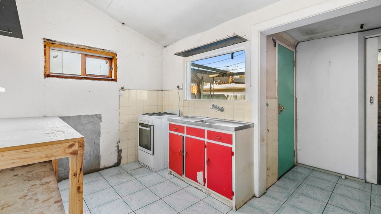 A kitchen with fixtures ripped off the wall.