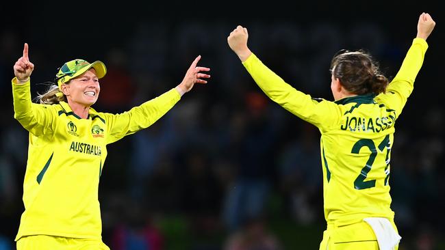 Captain Meg Lanning (left) celebrates with Jonassen after Australia’s 2022 Women's Cricket World Cup final win over England. Picture: Hannah Peters/Getty Images