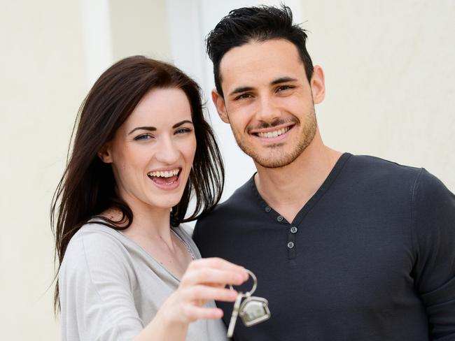 happy young couple welcome in their new house showing the door house keys. Young couple, first homebuyers.Picture: THINKSTOCK