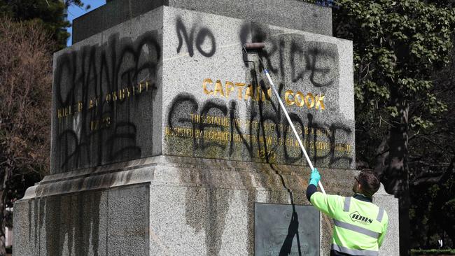 Council workers removing the graffiti on Captain James Cook’s statue in Hyde Park in 2017.