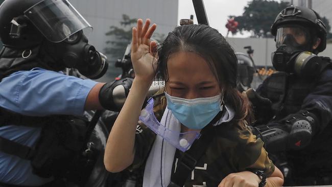 On Wednesday, a protester was tackled by riot police during a massive demonstration outside the Legislative Council in Hong Kong. Picture: AP/Kin Cheung