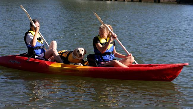 Cindy Miceli and Emma Miceli take their Labrador Lily on her first ever kayak ride on Currumbin Creek. Picture by Scott Fletcher