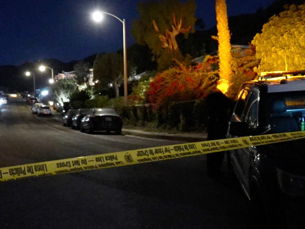 Police officers taped off the street outside Perry’s home following his tragic death. Picture: AFP