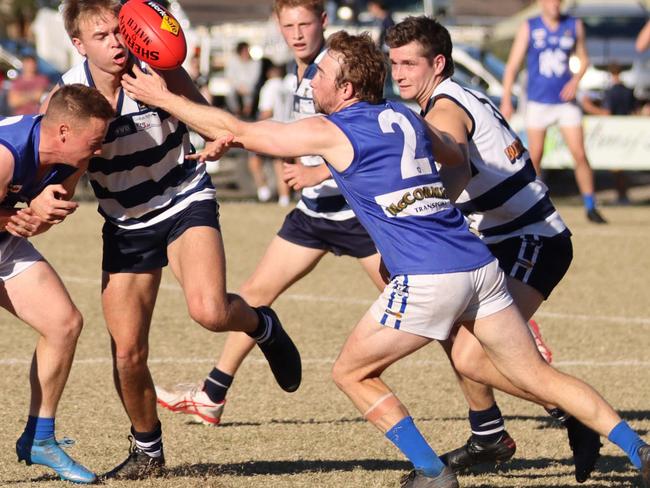 Hastings gun Nathan Gray (No 2) reaches for the ball. Pic: Doug Farr