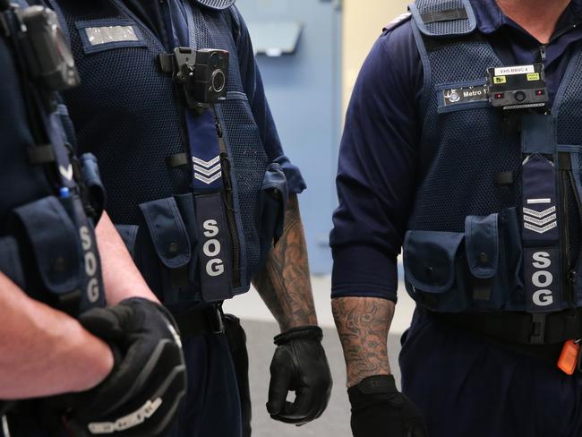 Corrective Services officers pictured with different types of body cameras currently being trialed during cell raids at Silverwater Jail whilst looking for contraband. Picture: Richard Dobson