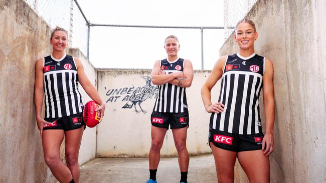 Port Adelaide AFLW captain Janelle Cuthbertson, forward Ashleigh Saint and midfielder Abbey Dowrick in the Power’s prison-bar guernsey. Picture: Matt Sampson