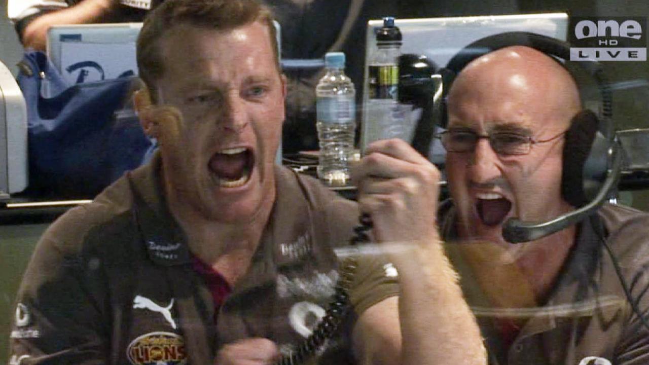 Michael Voss goes wild in the coaches box after a win as Brisbane coach.