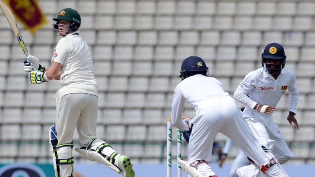 Australia's captain Steven Smith (L) was out stumped early on day two in Kandy.