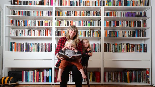 Emma Coyle and her kids Augie,2, and Violet,4, in front of their big bookcase. Picture: Tait Schmaal