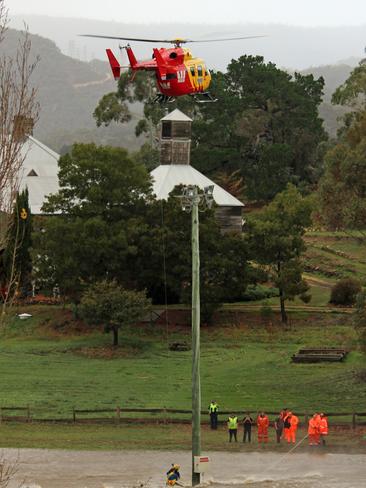 Then the Westpac chopper was called to New Norfolk to retrieve a 15-year-old boy stranded on an inundated cricket oval at Tynwald Park. Picture: DAMIAN BESTER