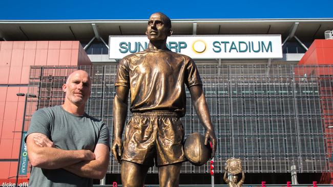 Former Broncos and Cowboys winger Scott Minto at Suncorp Stadium with the mock "bronze statue" created as a stunt by sports betting firm Sportsbet. Picture: David Kapernick