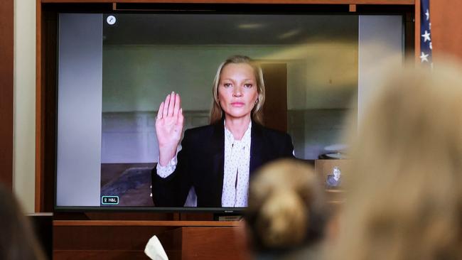 Kate Moss is sworn in via video link at the Fairfax County Circuit Courthouse in Fairfax, Virginia. (Photo by EVELYN HOCKSTEIN / POOL / AFP)