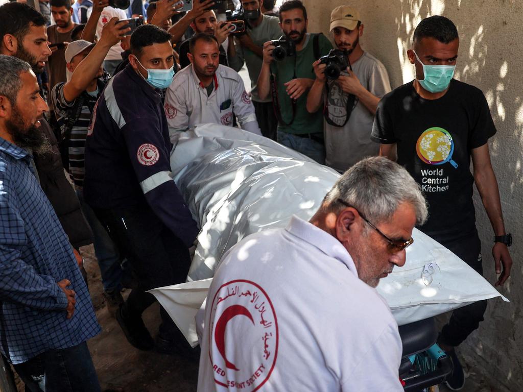 One of the bodies of staff members of the US-based aid group World Central Kitchen, is transported out of a hospital morgue in Rafah. Picture: AFP