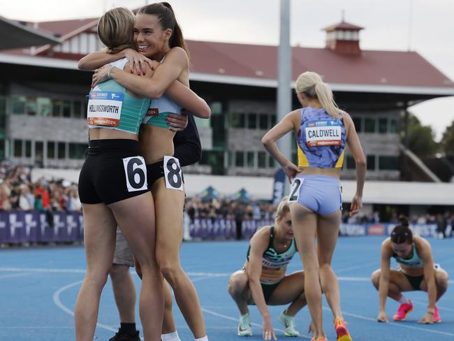 Claudia Hollingsworth hugs training partner Imogen Barrett after winning the 800 meres. Picture: Michael Klein