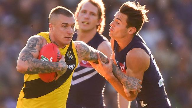 Lachie Weller tries to tackle Dustin Martin. (Photo by Daniel Carson/AFL Media/Getty Images)