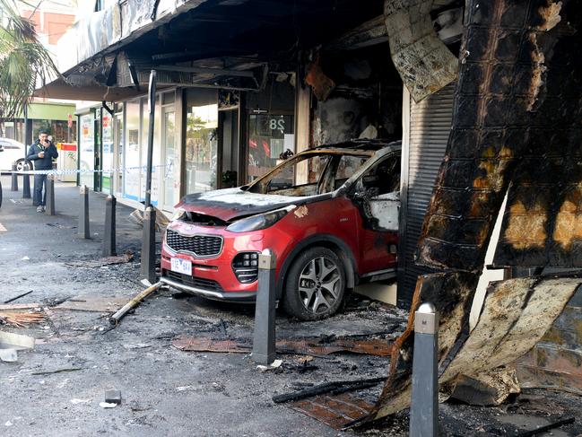 A burnt out car inside a tobacconists on Station Street Oakleigh, in the most recent in a string of arson attacks Picture: Andrew Henshaw