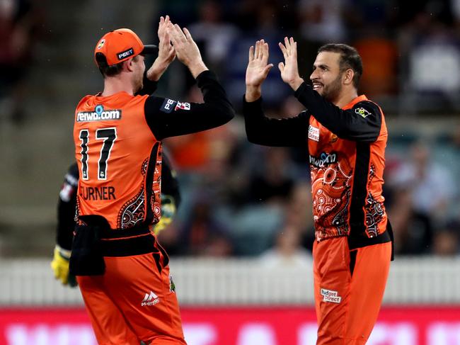 Scorchers skipper Ashton Turner and Fawad Ahmed celebrate a wicket.