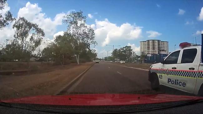 A cop car has narrowly avoided colliding with a Darwin motorist on the Stuart Hwy. Video: Brett Perry