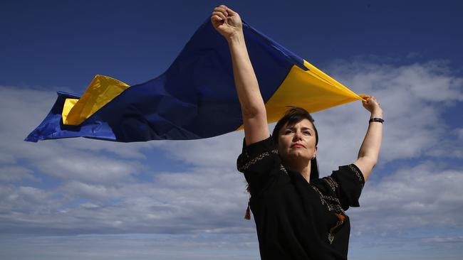 Natalia Borodina flying Ukrainian flag on Bronte Beach where she helps facilitate a learn to swim program out of Bronte Surf Club. Picture: John Appleyard