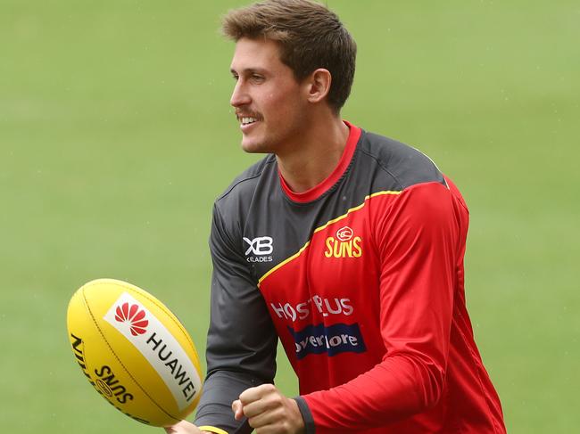 GOLD COAST, AUSTRALIA - MARCH 27: David Swallow handballs during a Gold Coast Suns AFL training session at Metricon Stadium on March 27, 2019 in Gold Coast, Australia. (Photo by Chris Hyde/Getty Images)