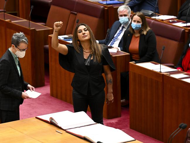 Australia Greens Senator for Victoria Lidia Thorpe raises her arm during her swearing-in ceremony in the Senate chamber at Parliament House in Canberra, Monday, August 1, 2022. (AAP Image/Lukas Coch) NO ARCHIVING